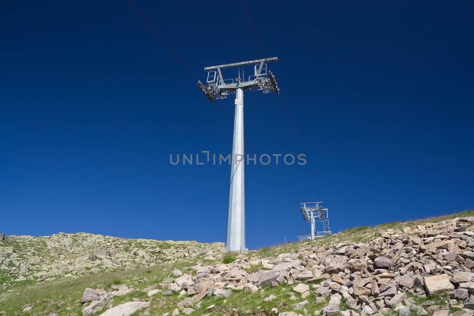summer view of ski lift under a deep blue sky. Photo taken with polarized filter