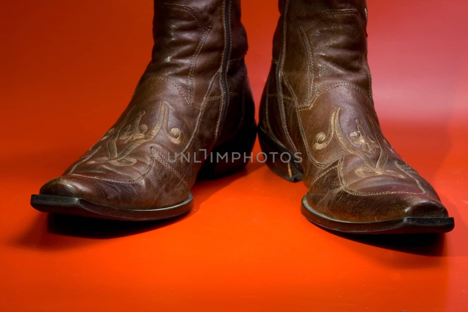 The ornate man's boots  on a red background