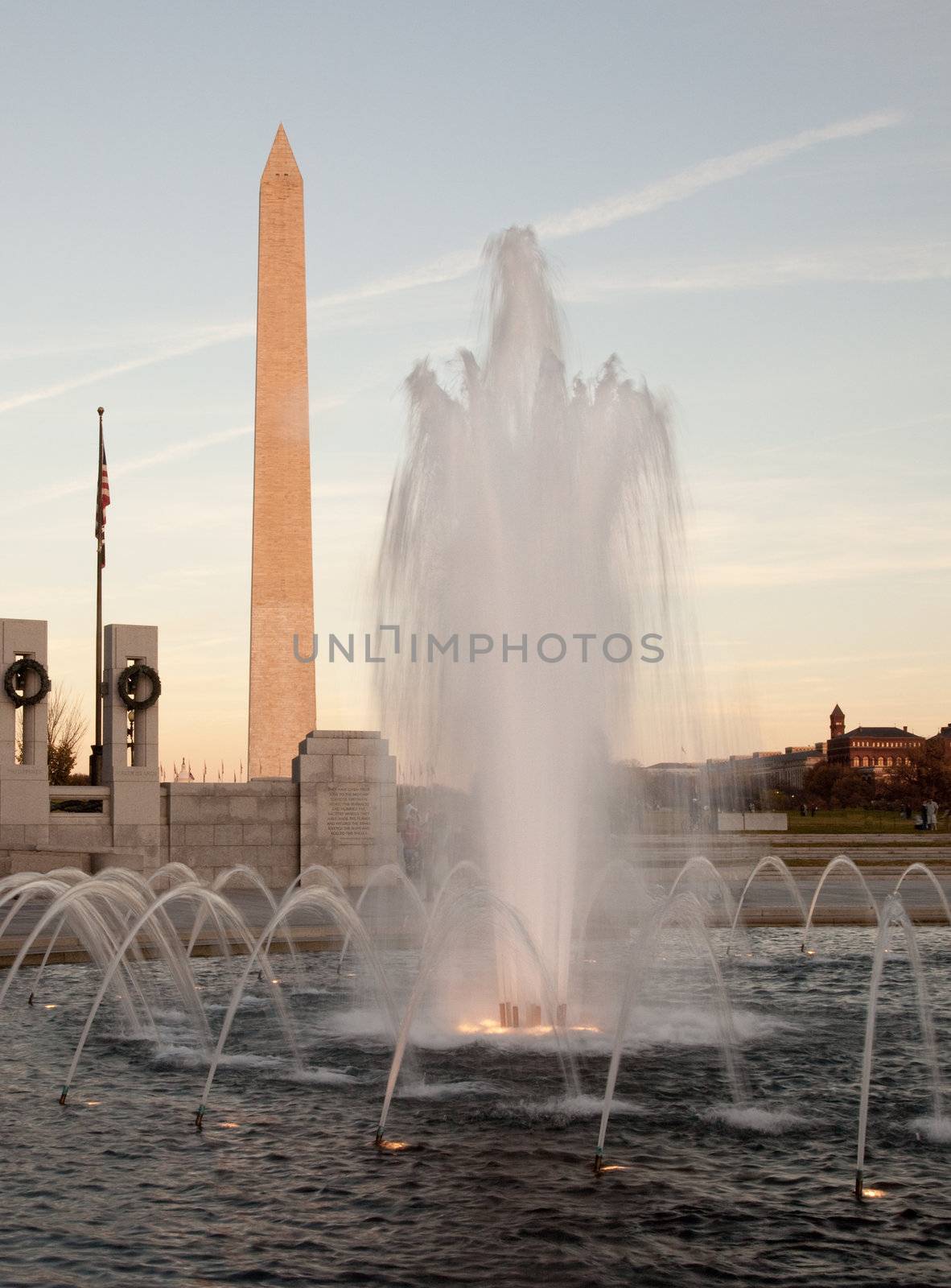 Washington Monument behind fountain at sunset by steheap
