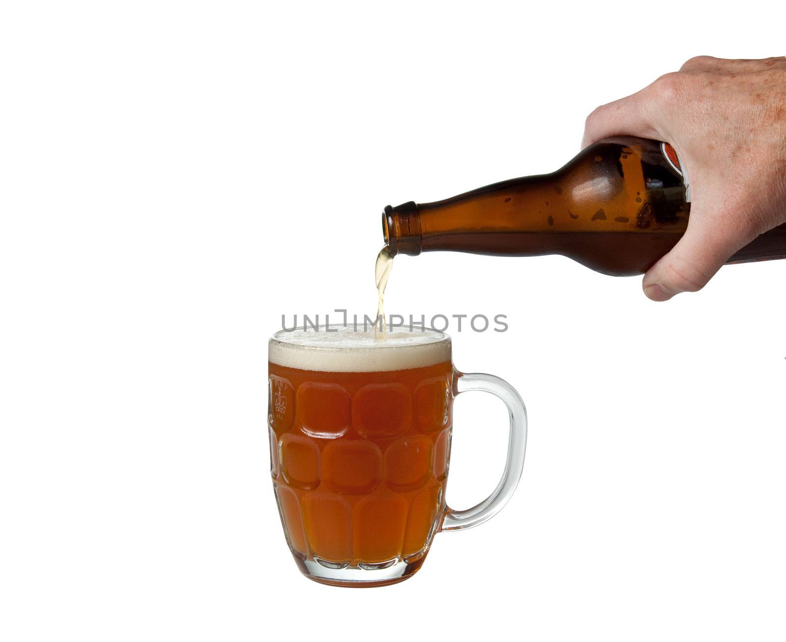Beer being poured from bottle into pint by steheap
