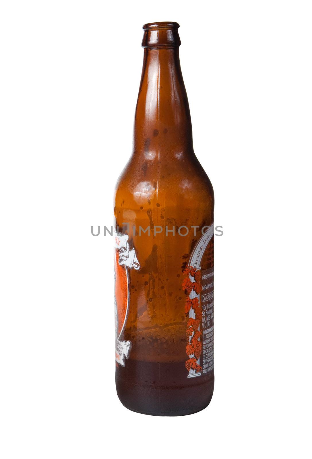Brown bottle of cold beer almost empty