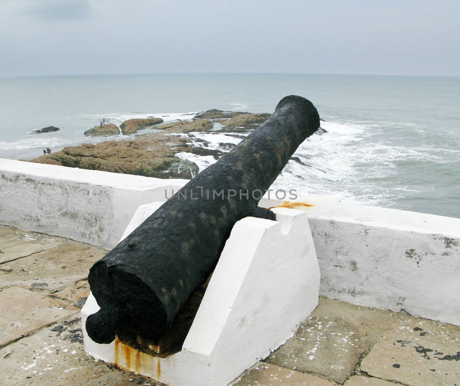 Elmina castle rusty gun overlooking ocean by steheap
