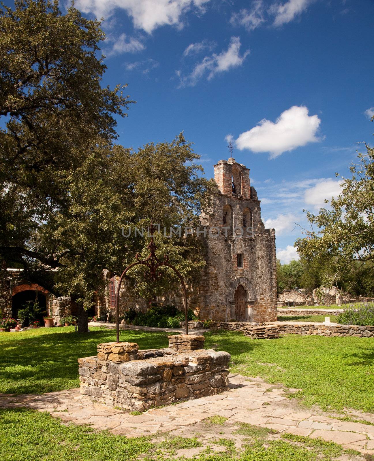 View of the garden and well in front of the Mission Espada near San Antonio in Texas
