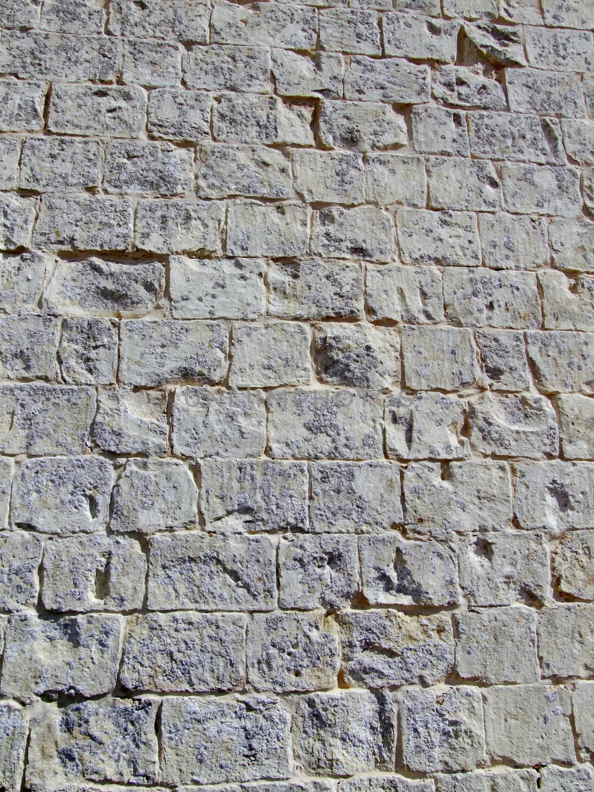 Detail and texture of medieval buildings. Limestone wall in Malta.