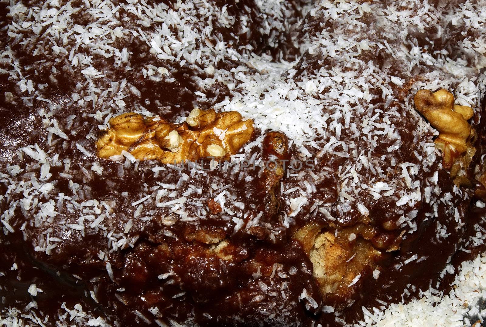 Christmas log cake with chocolate and coconut and nut dressing