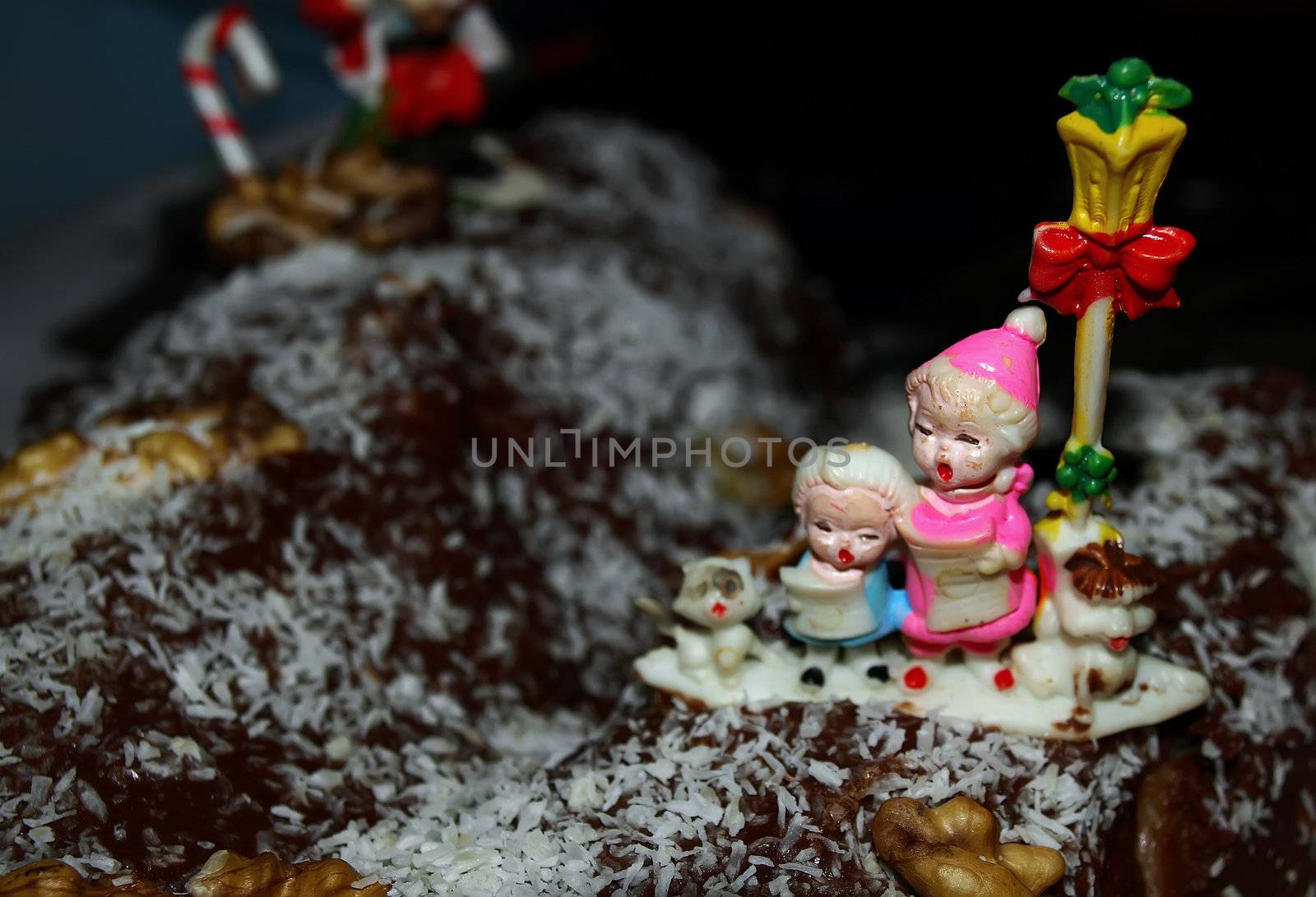 Christmas cake with chocolate and coconut and nut dressing with ornaments