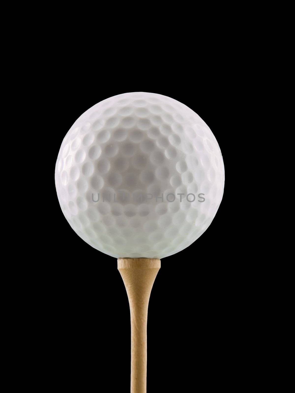 Golf ball on a tee, isolated on black