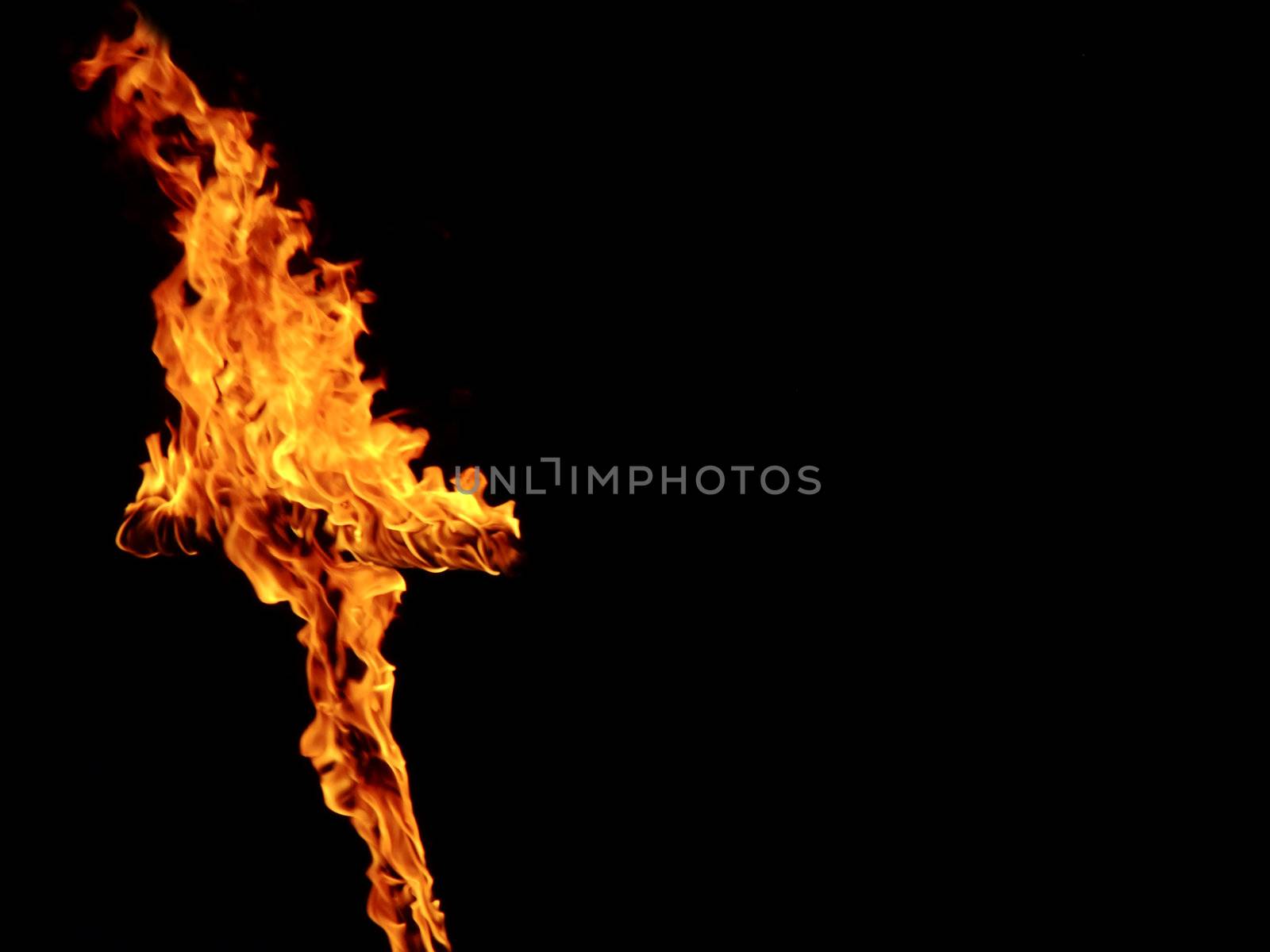 Burning crosses being used as part of ritual, on black background
