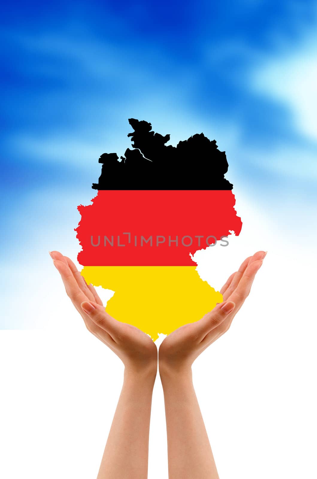 Hands holding a germany country map on cloud background.