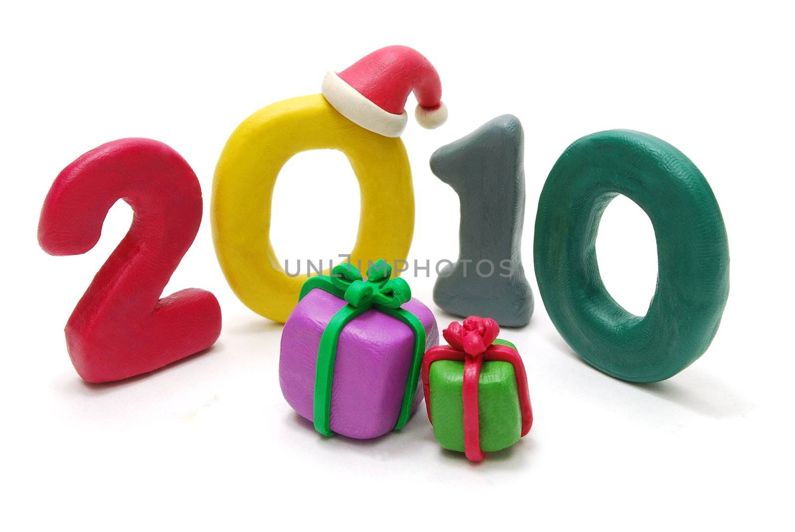 3D New Year Text 2010 with Santa Claus Hat and Gifts on Foreground Made of Colored Plasticine Isolated on White