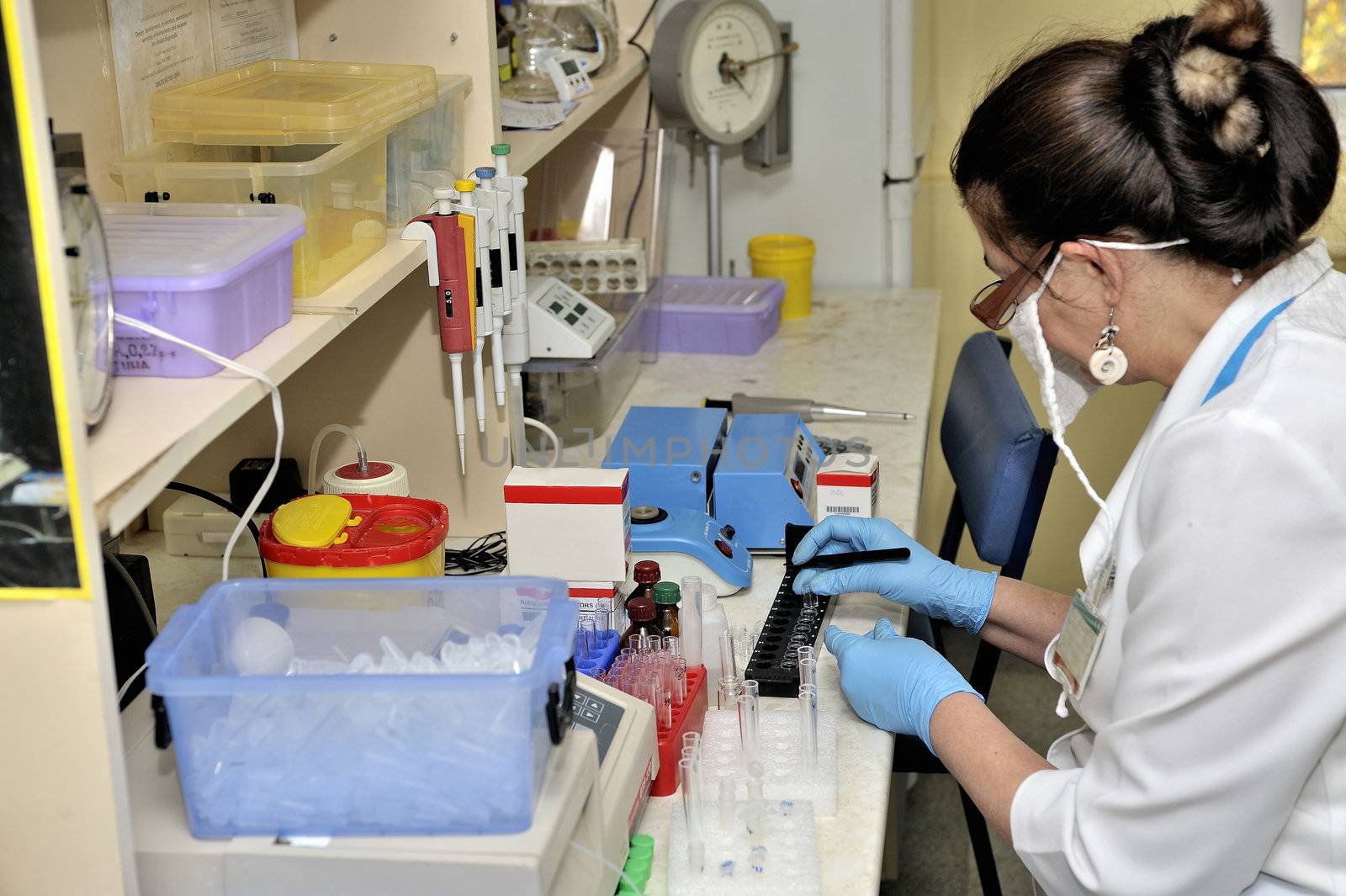 laboratory assistant working in medical laboratory. Marking medical samples.