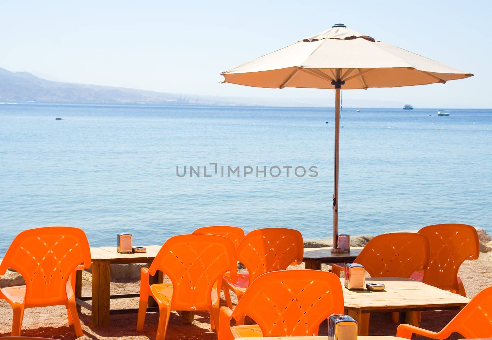 Summer cafe on the sea beach. by Vladimir