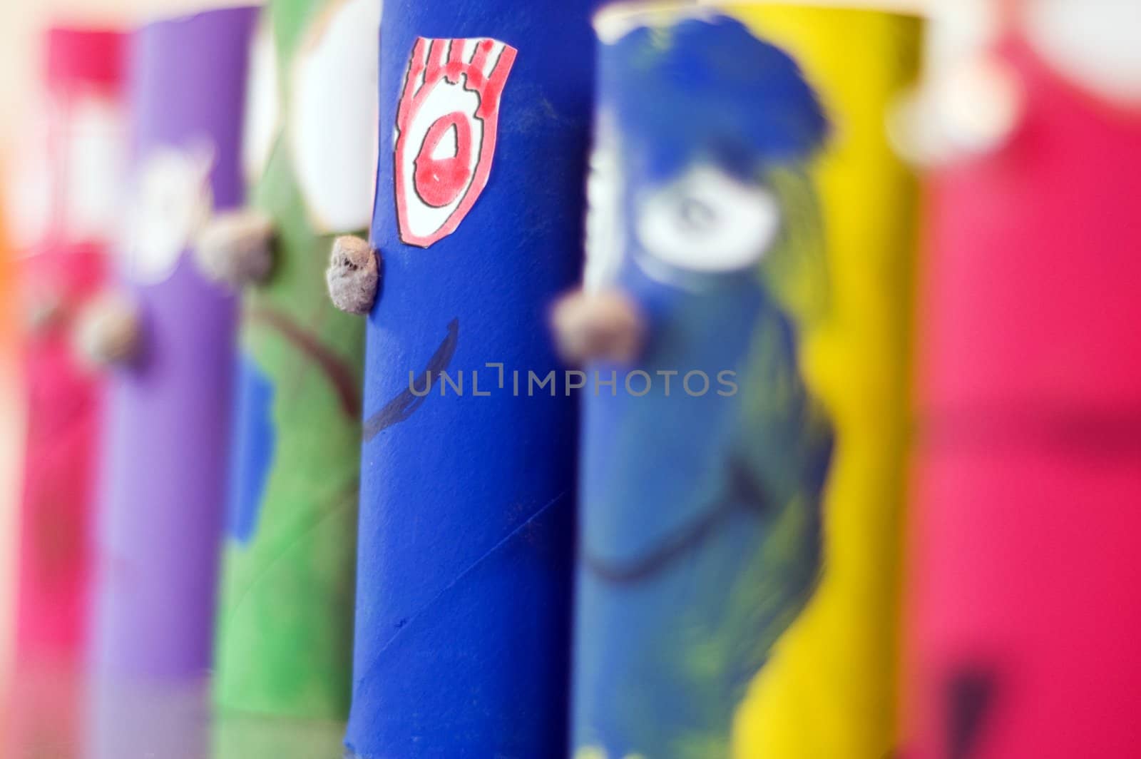 colored cylinder shaped puppets standing
