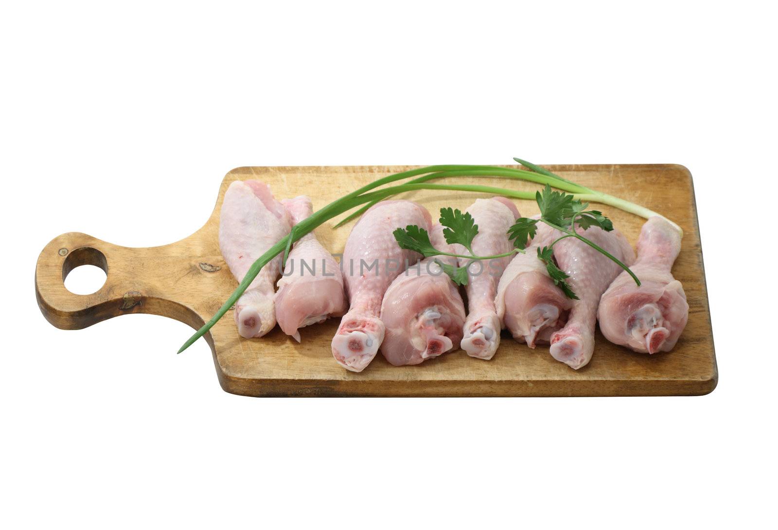 Few raw chiken legs on hardboard isolated with clipping path
