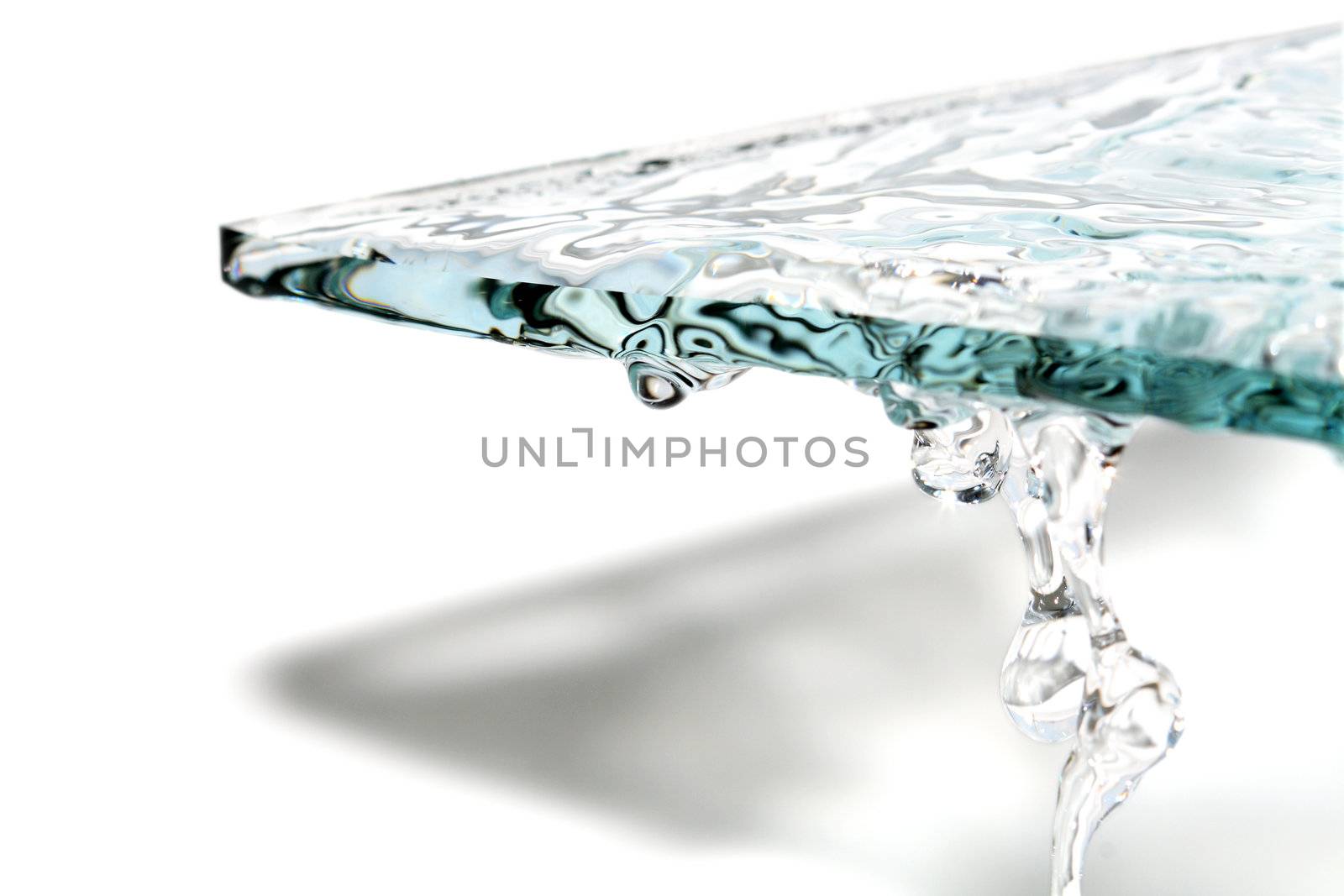 Abstract composition with glass and flowing water on white background
