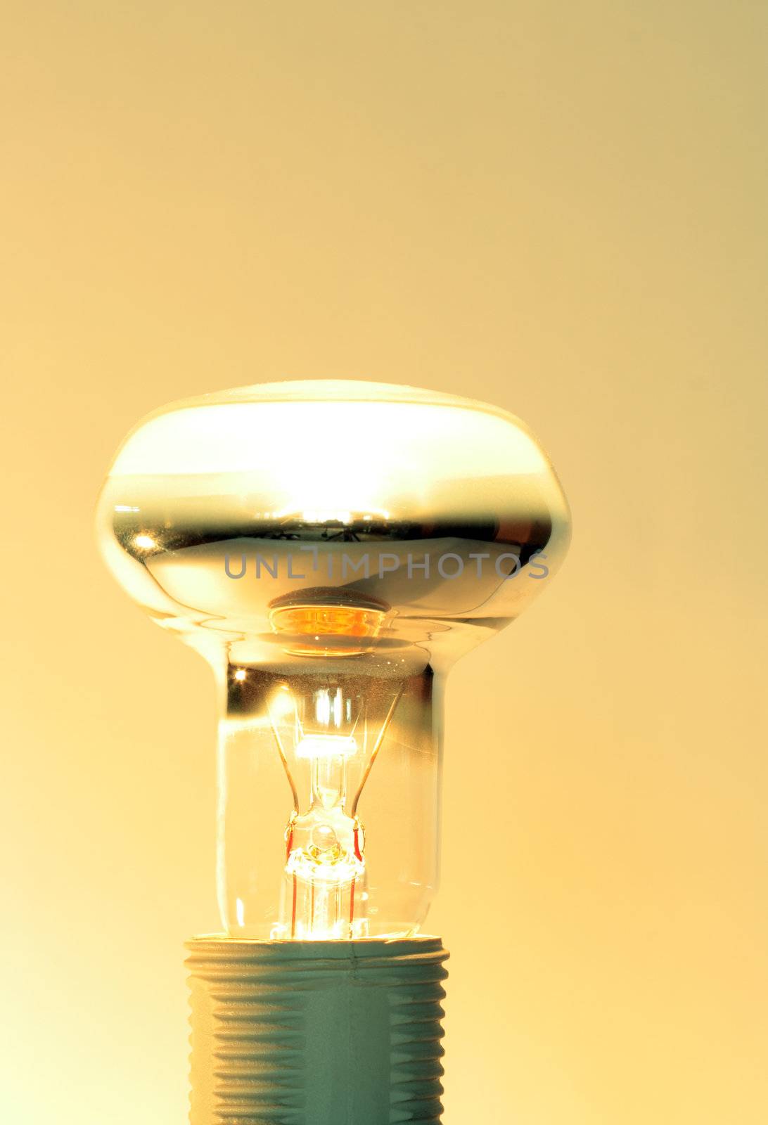 Luminous light bulb isolated on yellow background with copy space