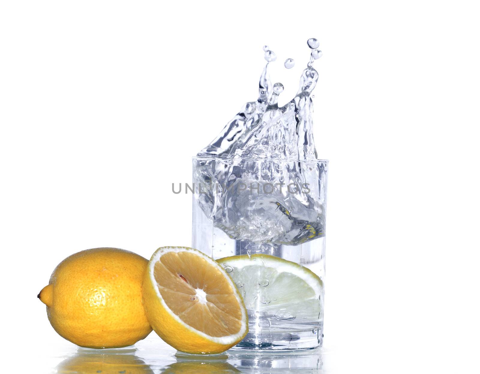 Lemon near glass of splashing water isolated on white background with clipping path