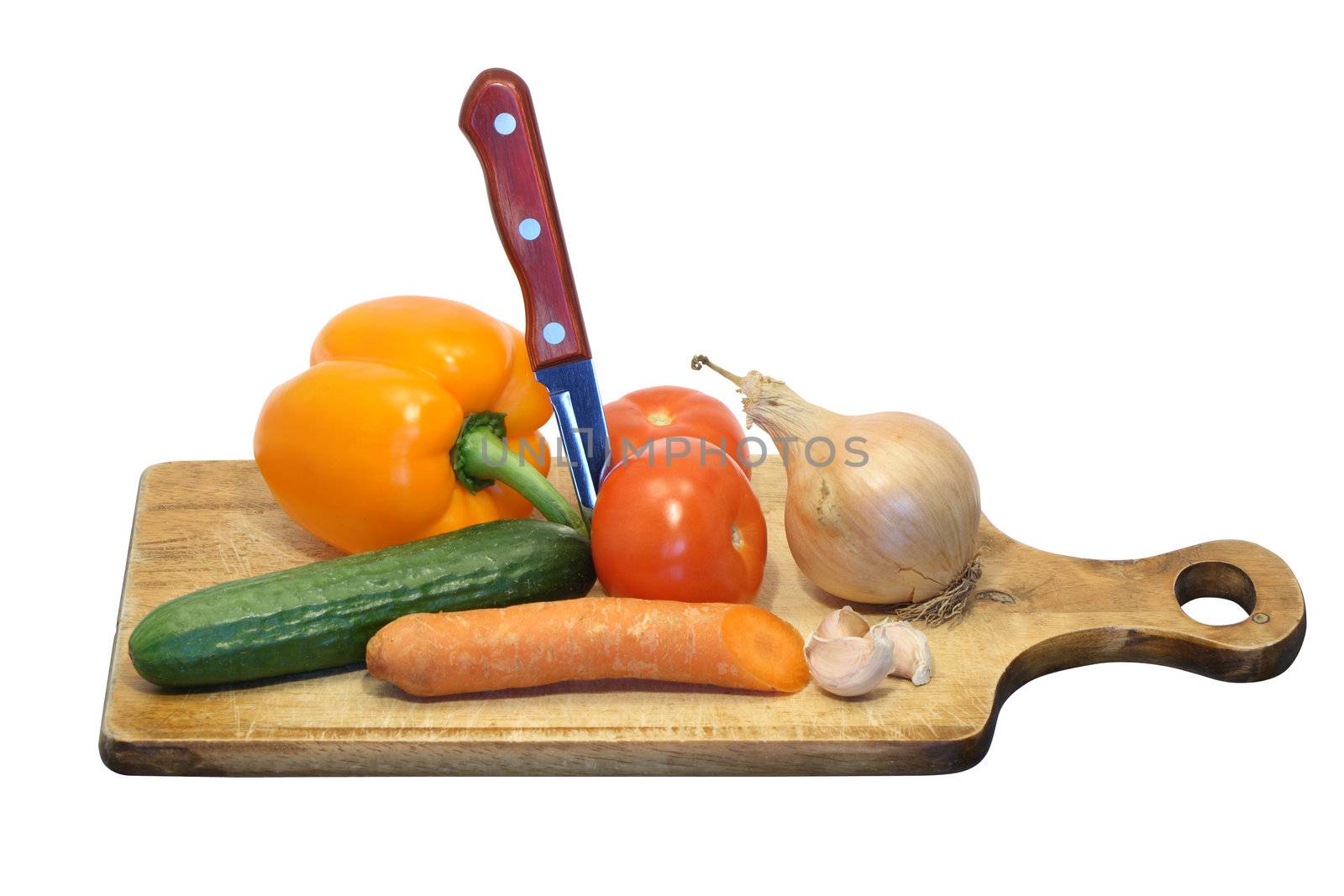 Various vegetables and knife on wooden breadboard isolated on white with clipping path