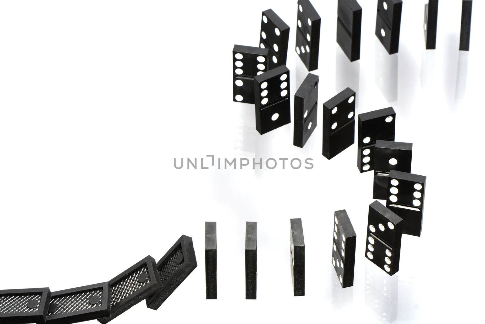 A stack of dominoes falling on white background with copy space