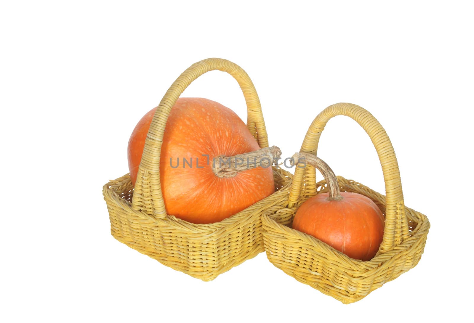 Two yellow wicker baskets with pumpkins isolated on white with clipping path