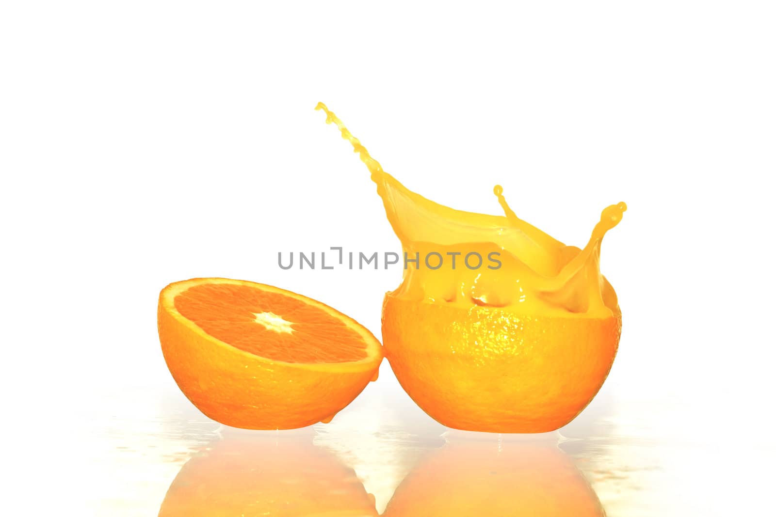 Two orange halfs with juice splash. Isolated on white with clipping path