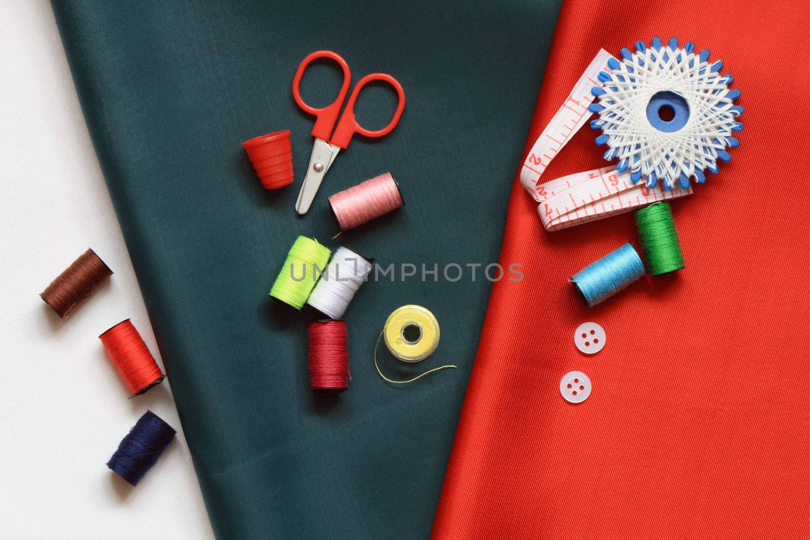 Sewing set lying on various colored cloth