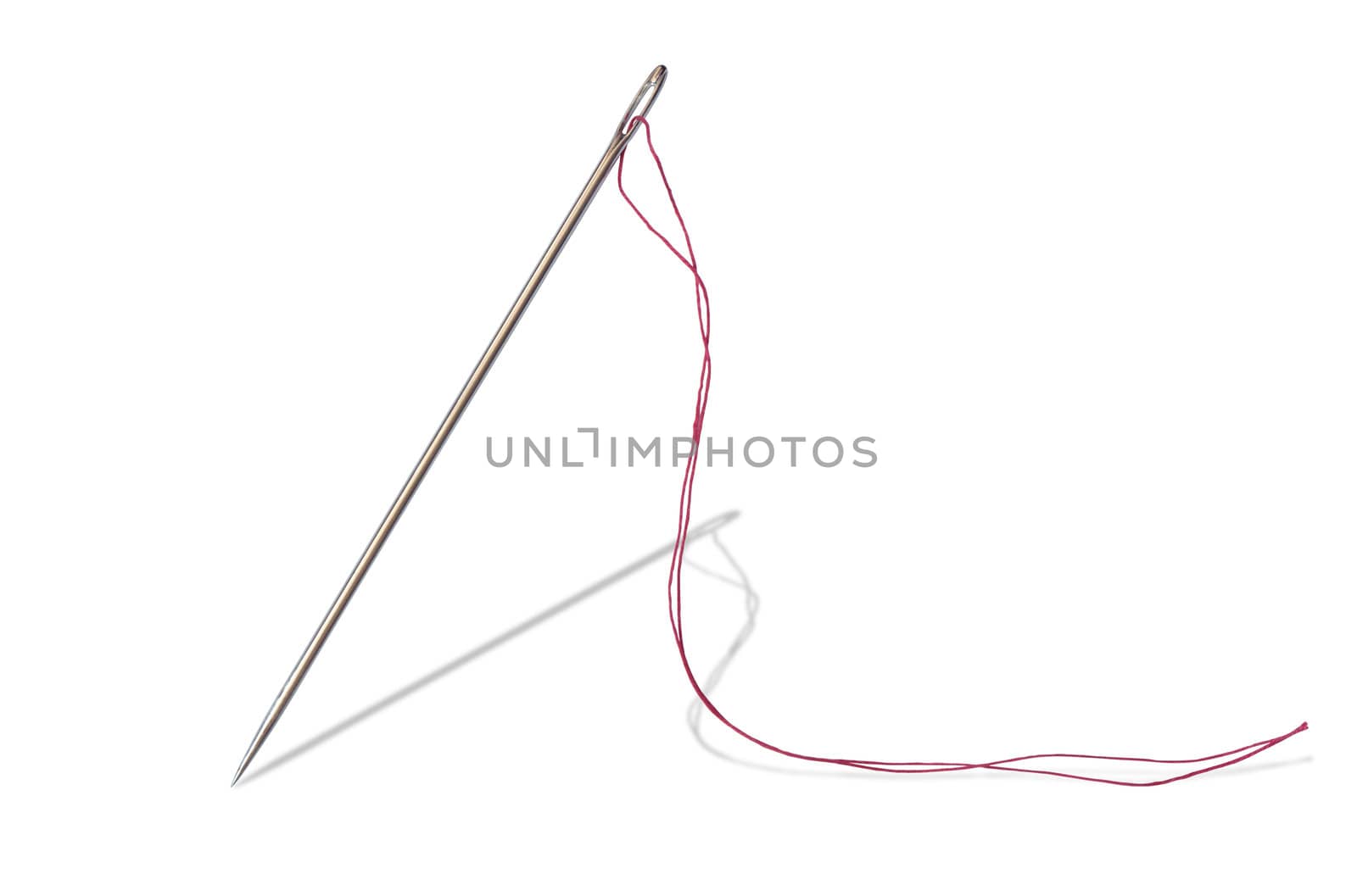 Closeup of sewing needle and red thread standing on white background. Isolated with clipping path