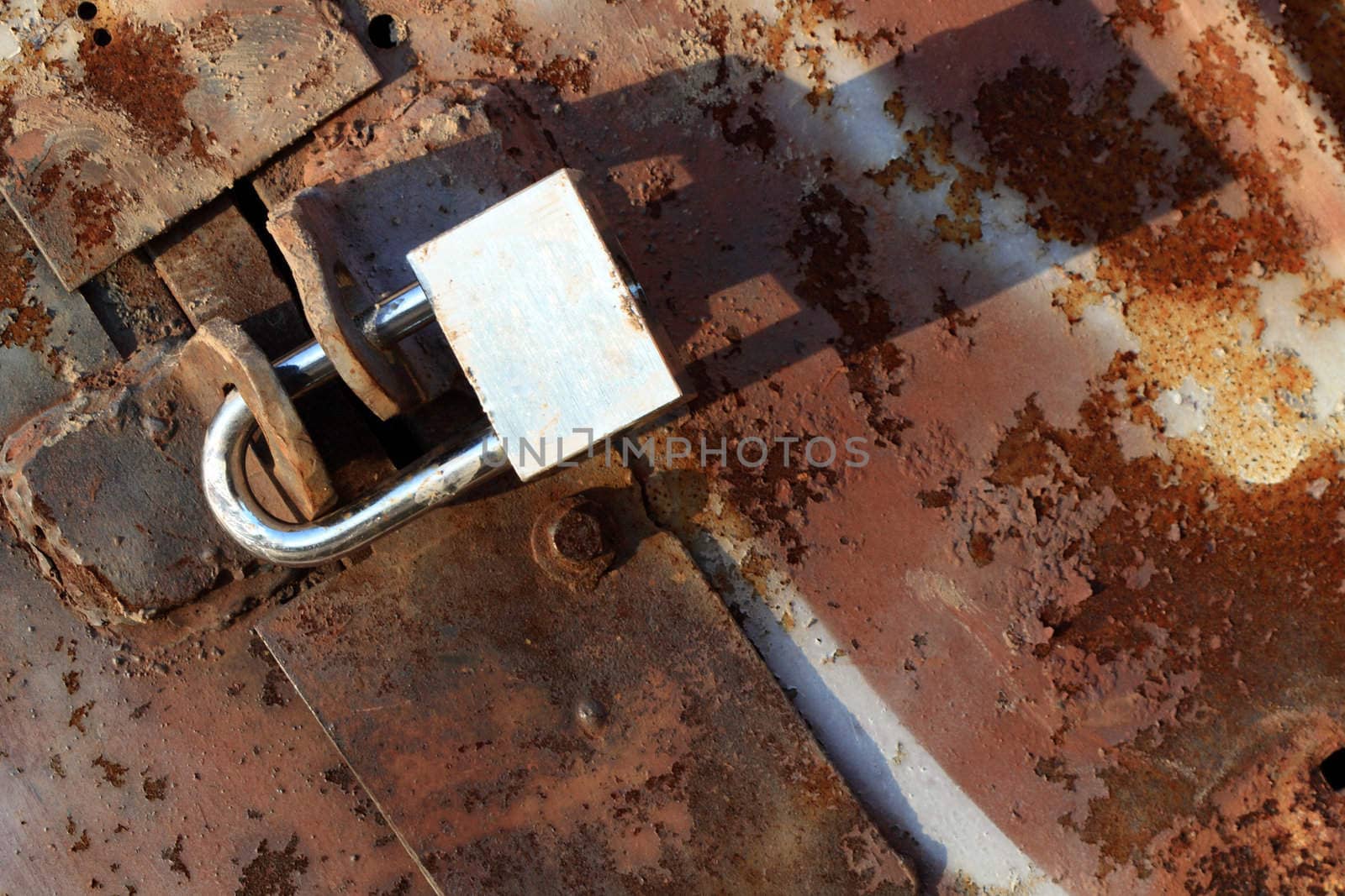 Old rusty brown metal background and lock with copy space