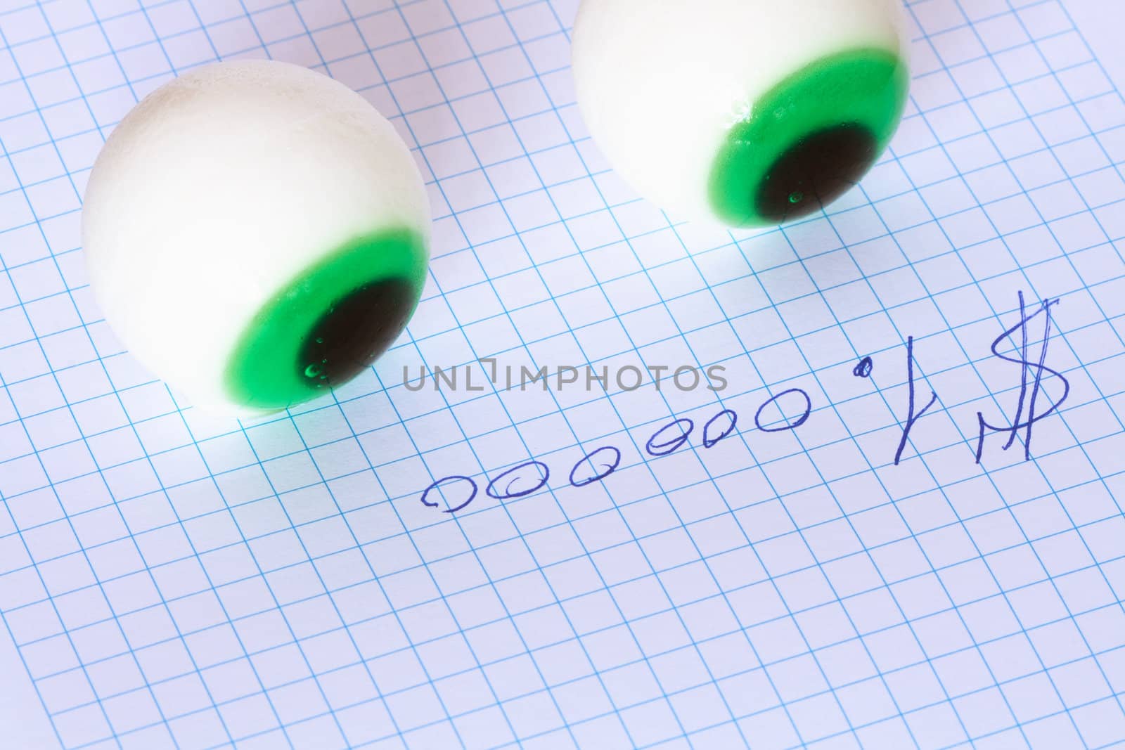 Two toy eyes lying on paper with inscription One million dollars