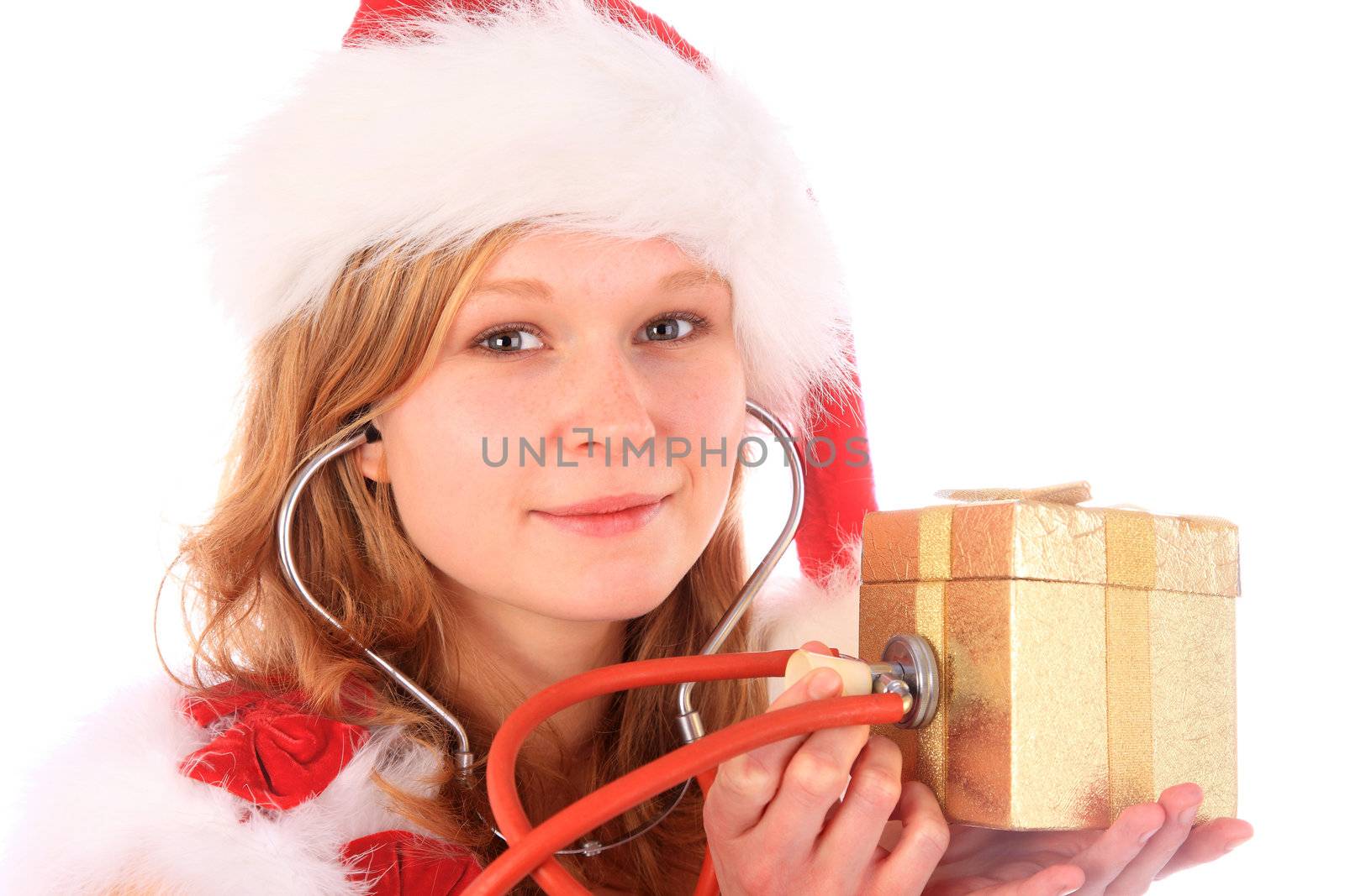 miss santa is sounding a golden gift box with a stetoscope to check out the gift box content - smiling at the camera