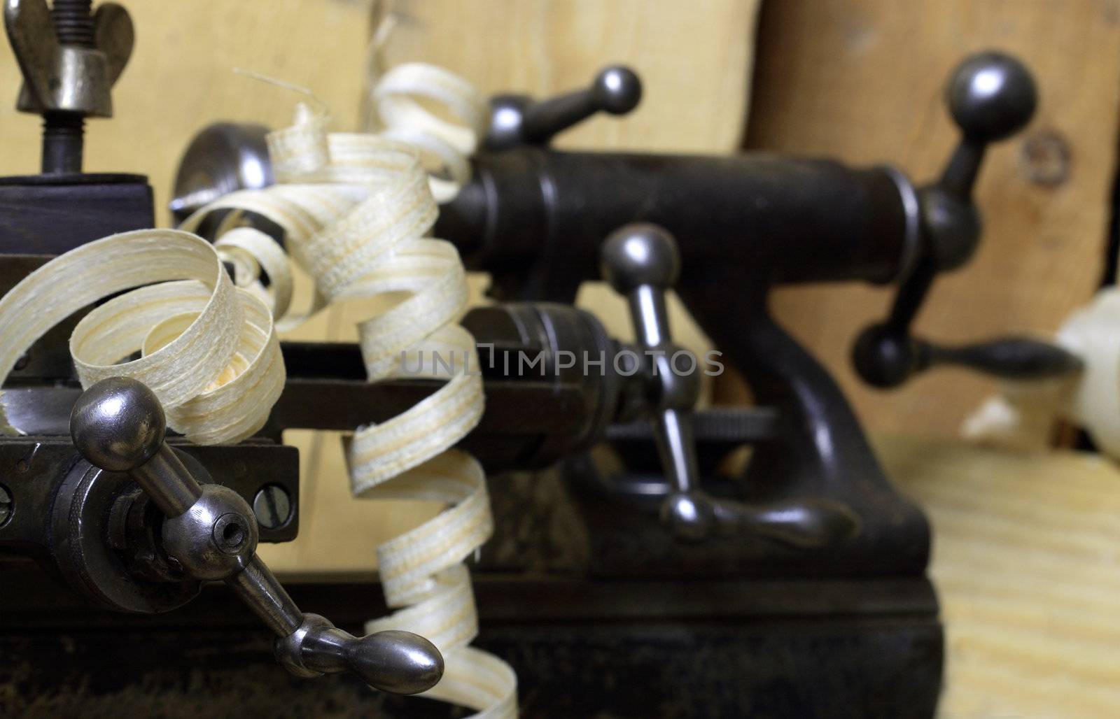 Extreme closeup of old lathe on wooden background with copy space