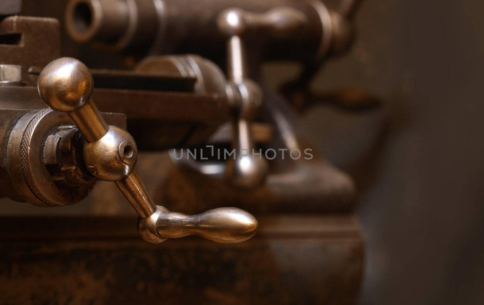 Extreme closeup of old lathe on dark background with copy space