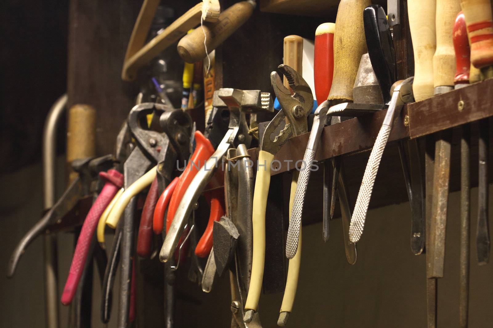 Close up of tools hanging on the house workshop wall