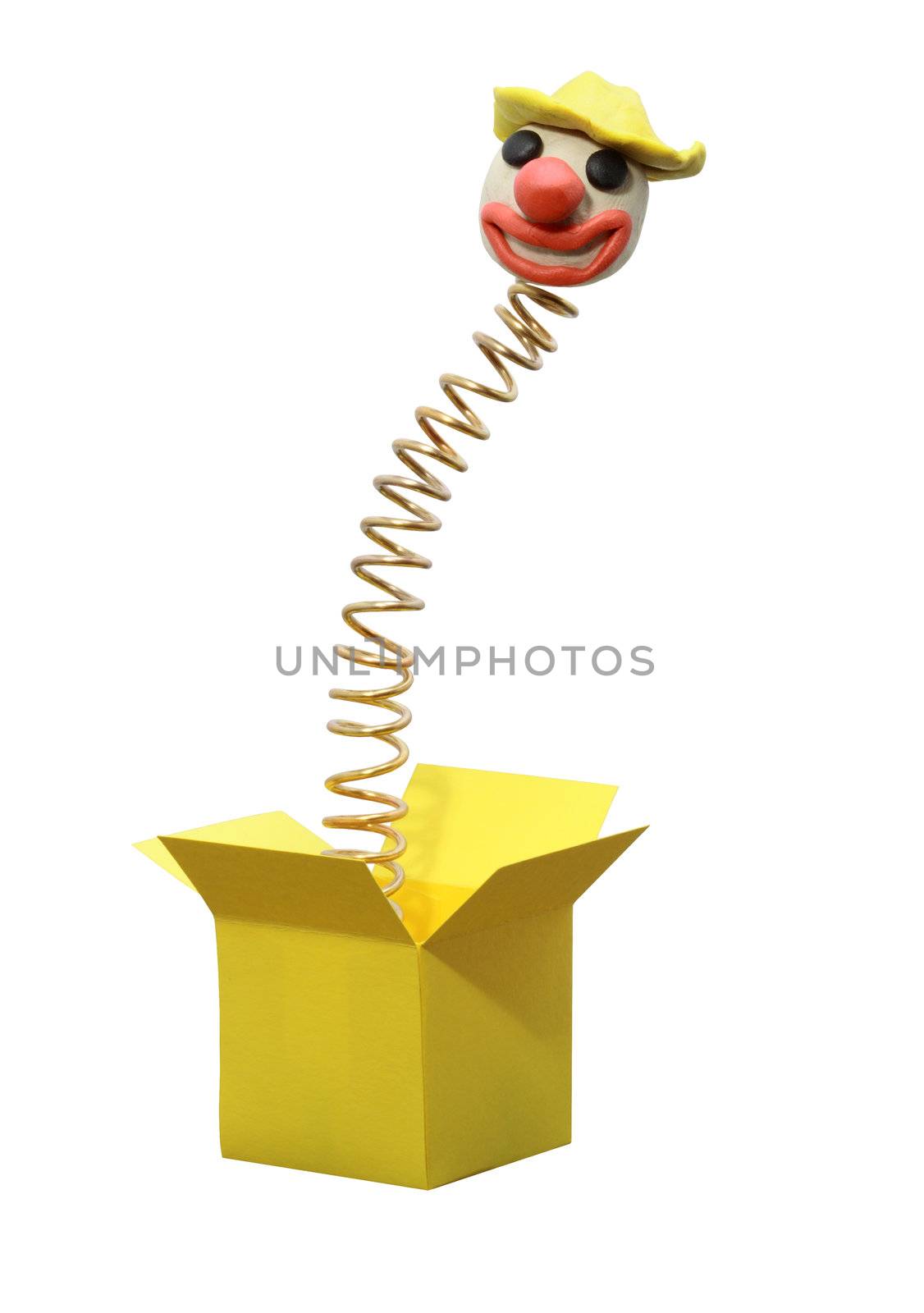 Clown head jumping from yellow paper box