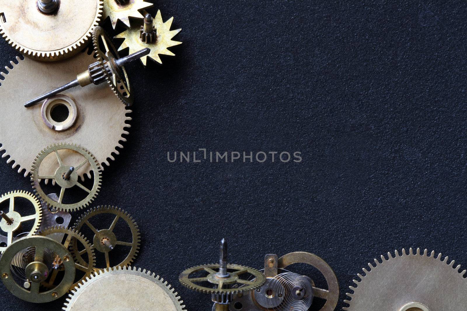 Old assorted gearwheels isolated on dark background with copy space