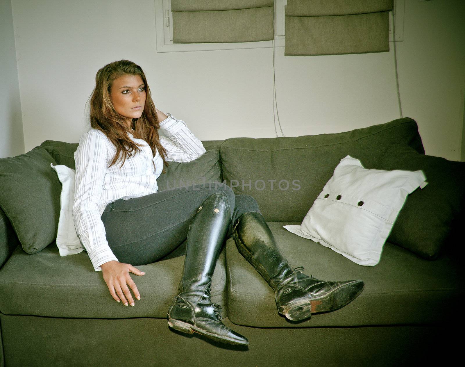 young provocative woman with a horsewhip lying on a sofa by macintox