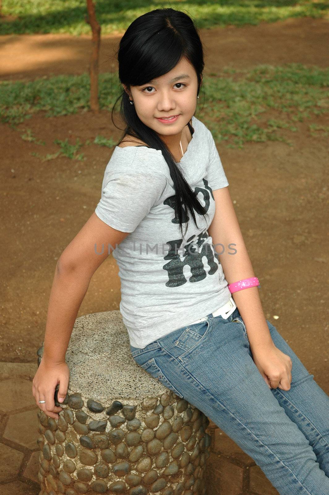 young asian lady sit down in park