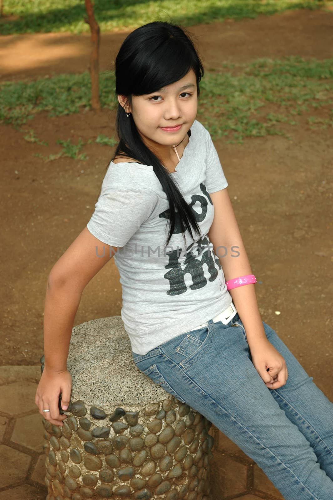 young asian lady sit down in park