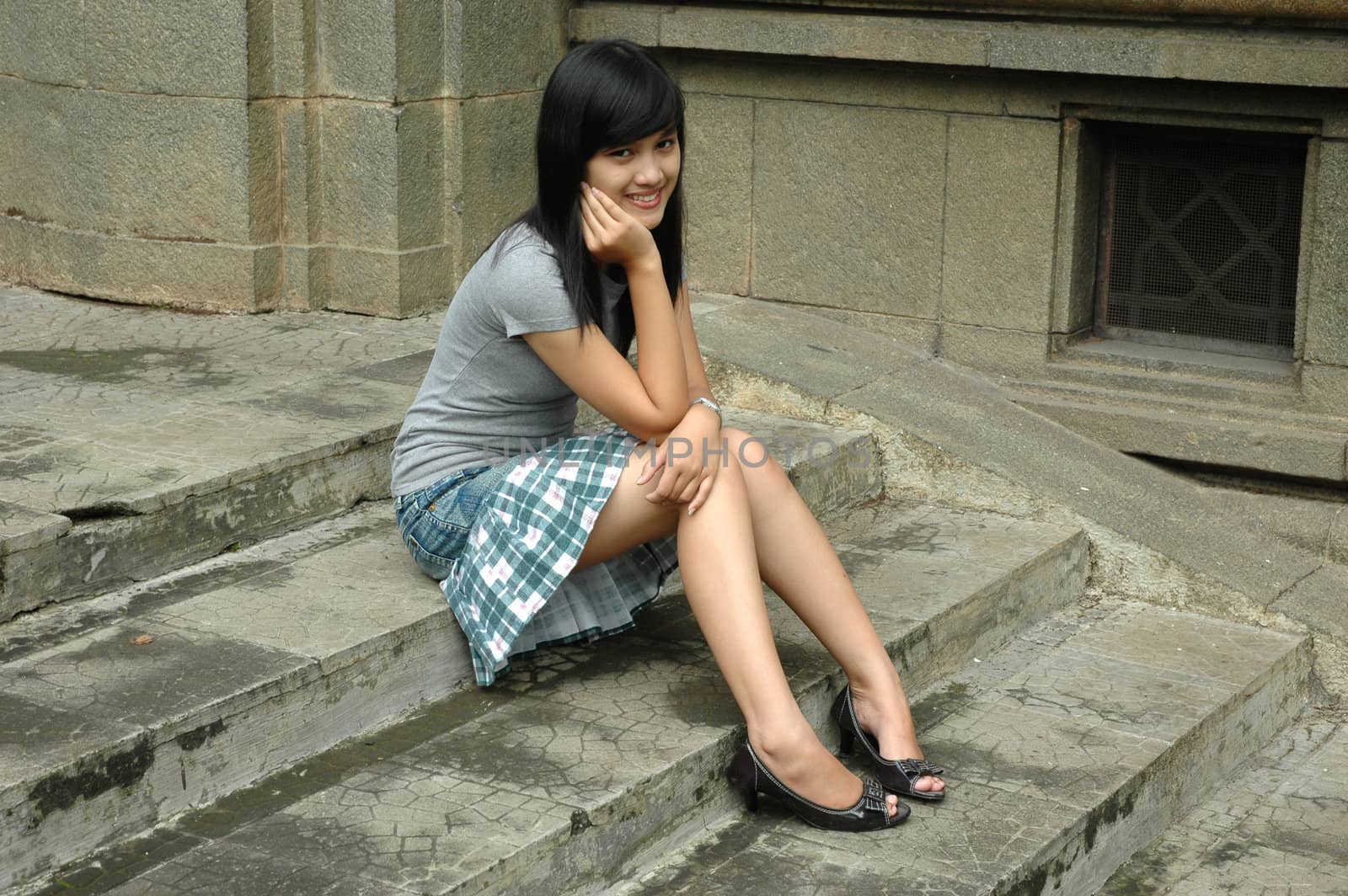 young asian lady sit down in park