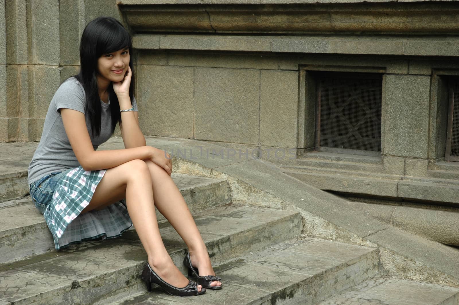 young asian lady sit down in park