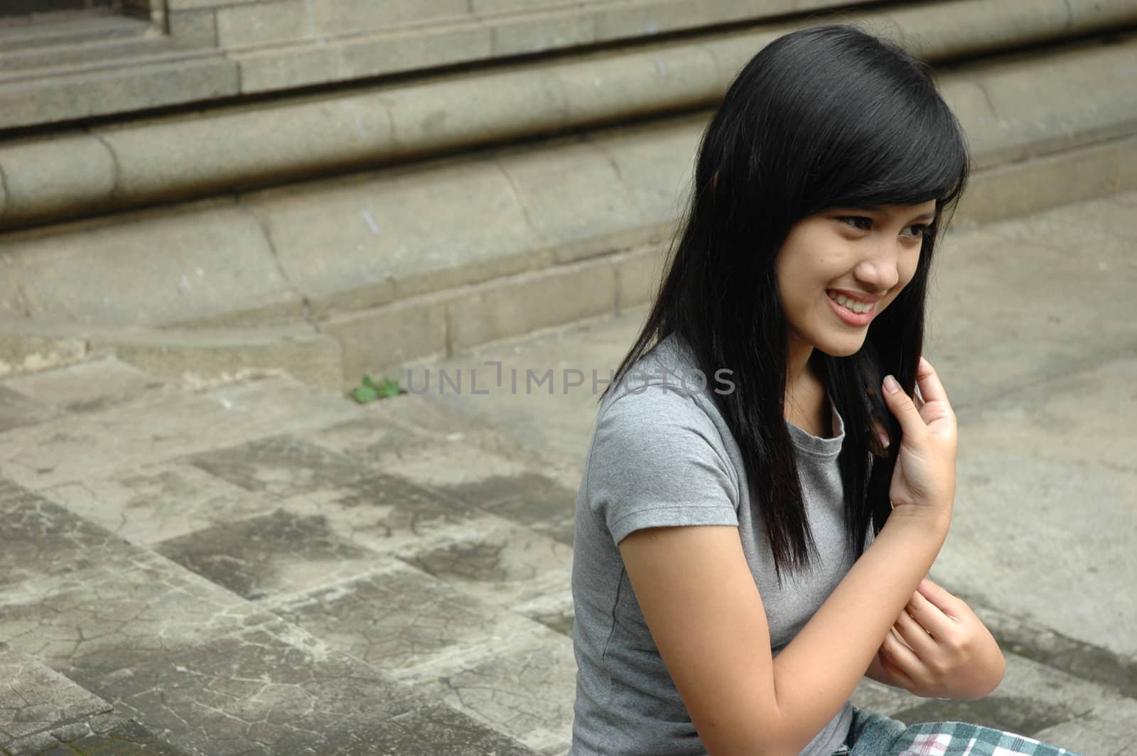 young asian lady sit down in park