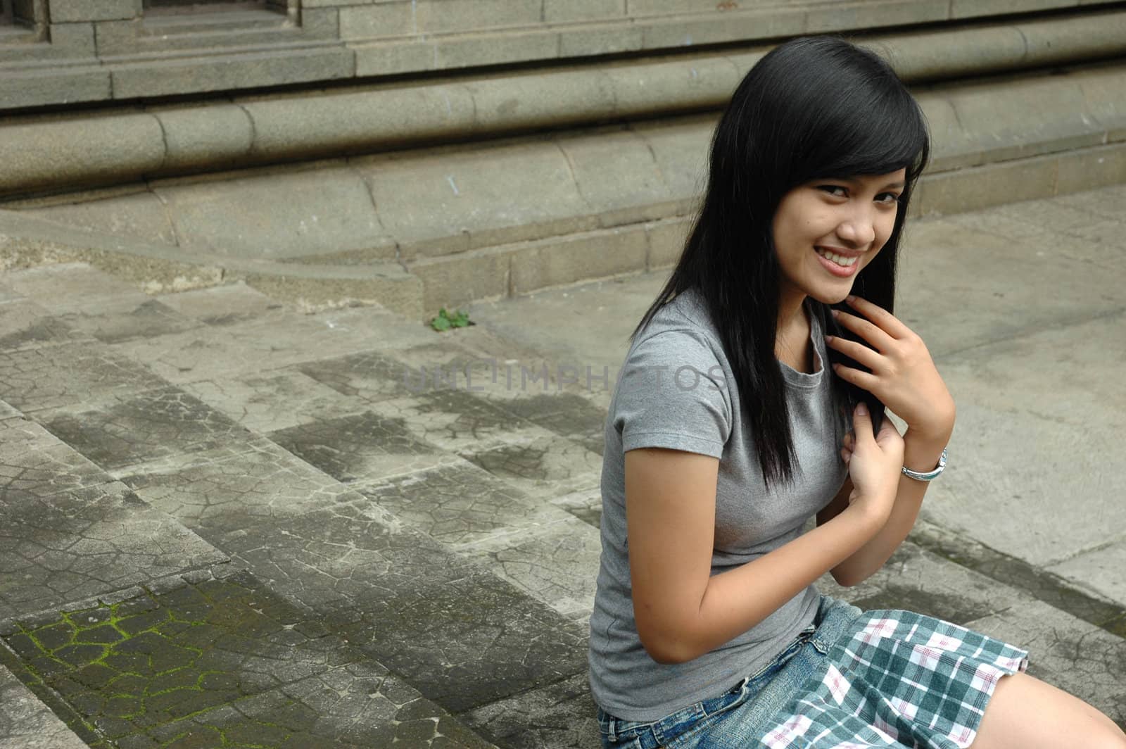 young asian lady sit down in park