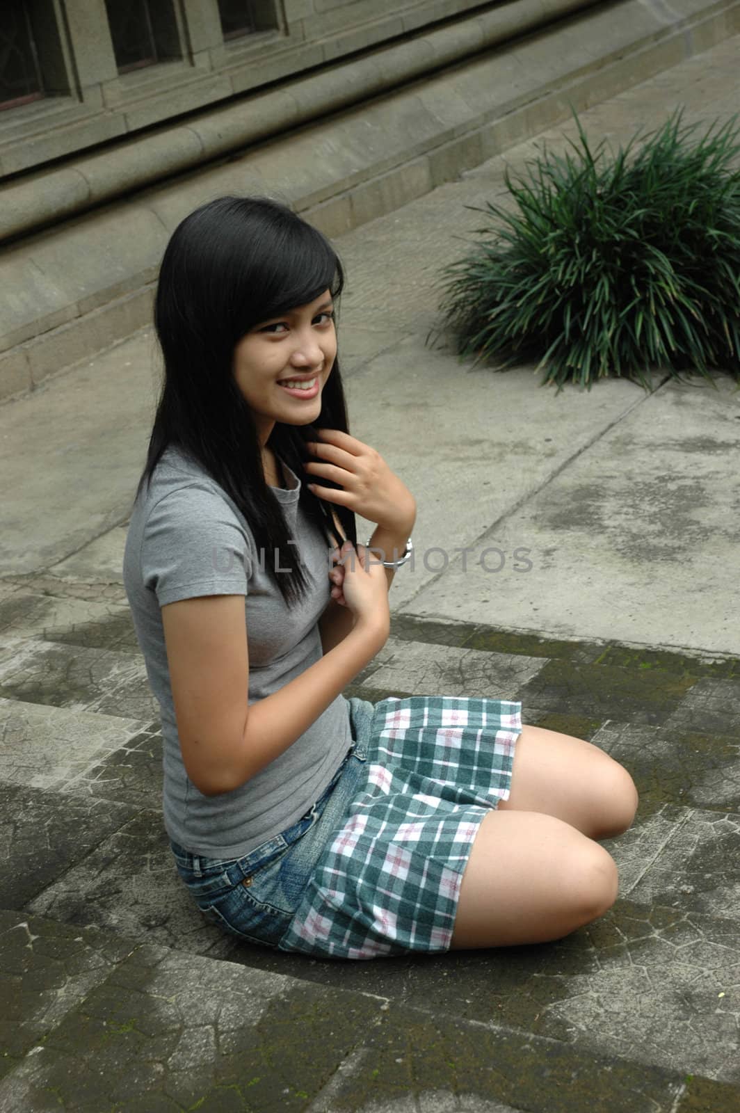 young asian lady sit down in park