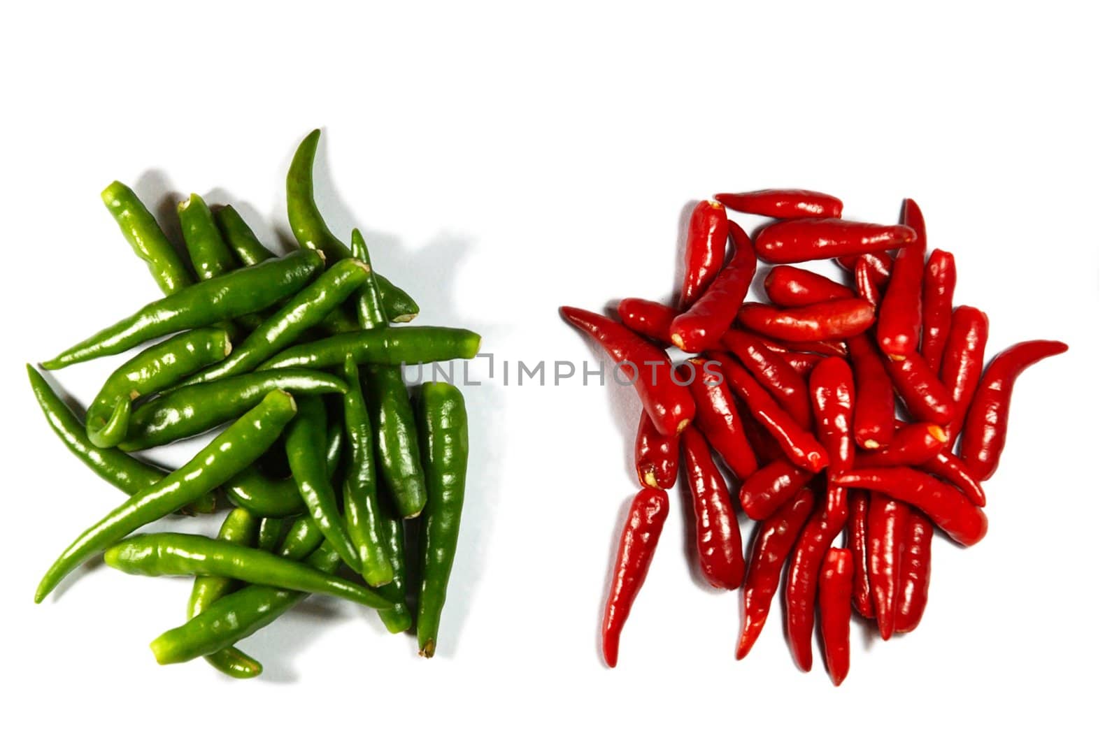 heaps of red and green spicy peppers isolated on white 