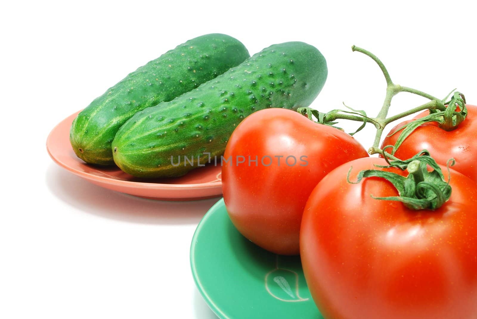 Three Red Tomatoes  and Two Cucumbers on Plate