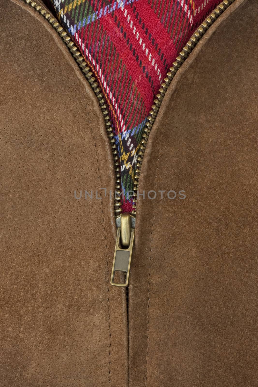 unzipped brass zipper of leather jacket by PixelsAway