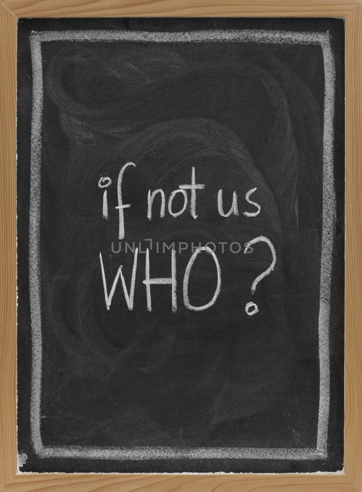 if not us, who - question handwritten with white chalk on blackboard, eraser smudge patterns