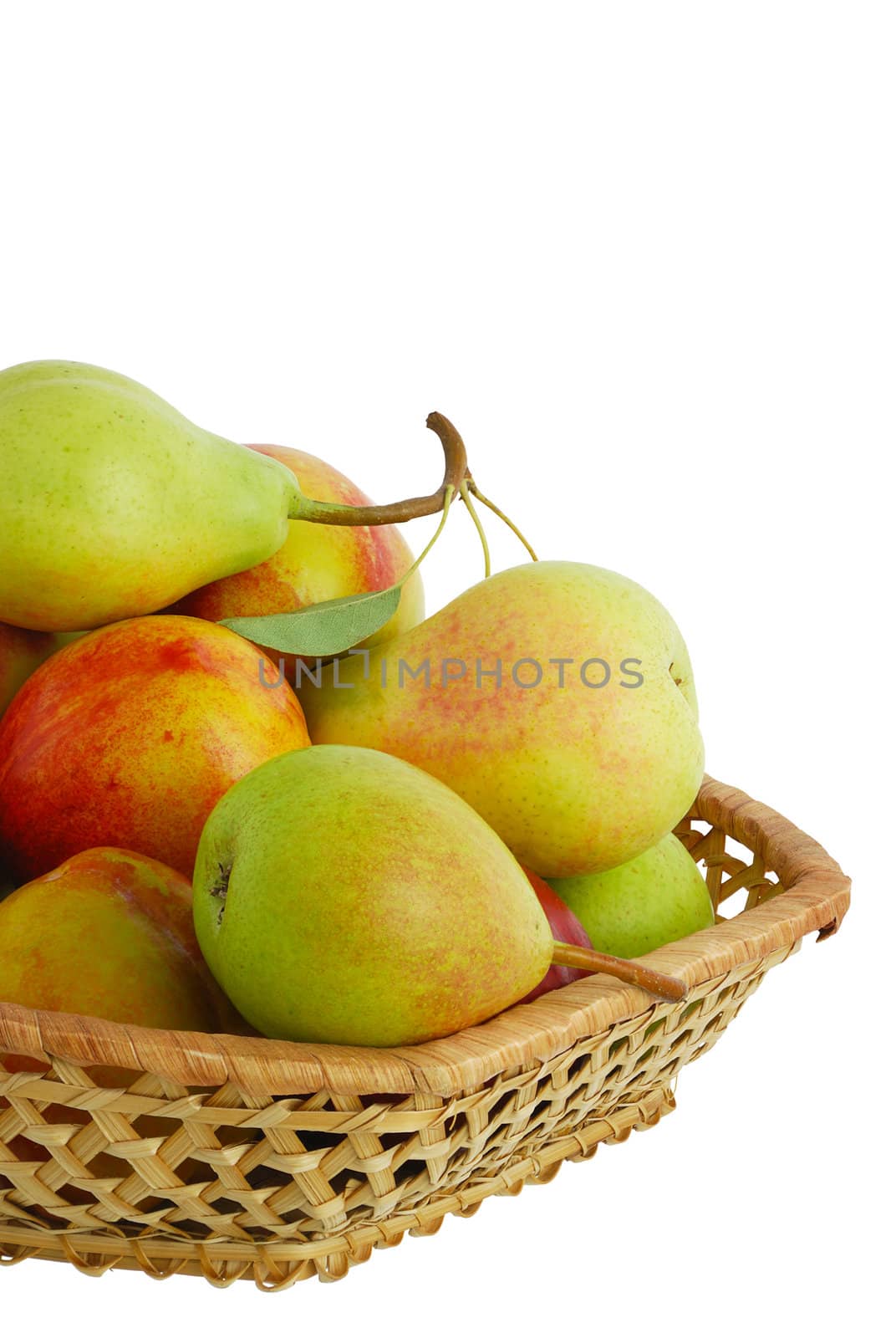 Cropped closeup of fresh pears, peaches and nectarines in interwoven basket isolated on white background