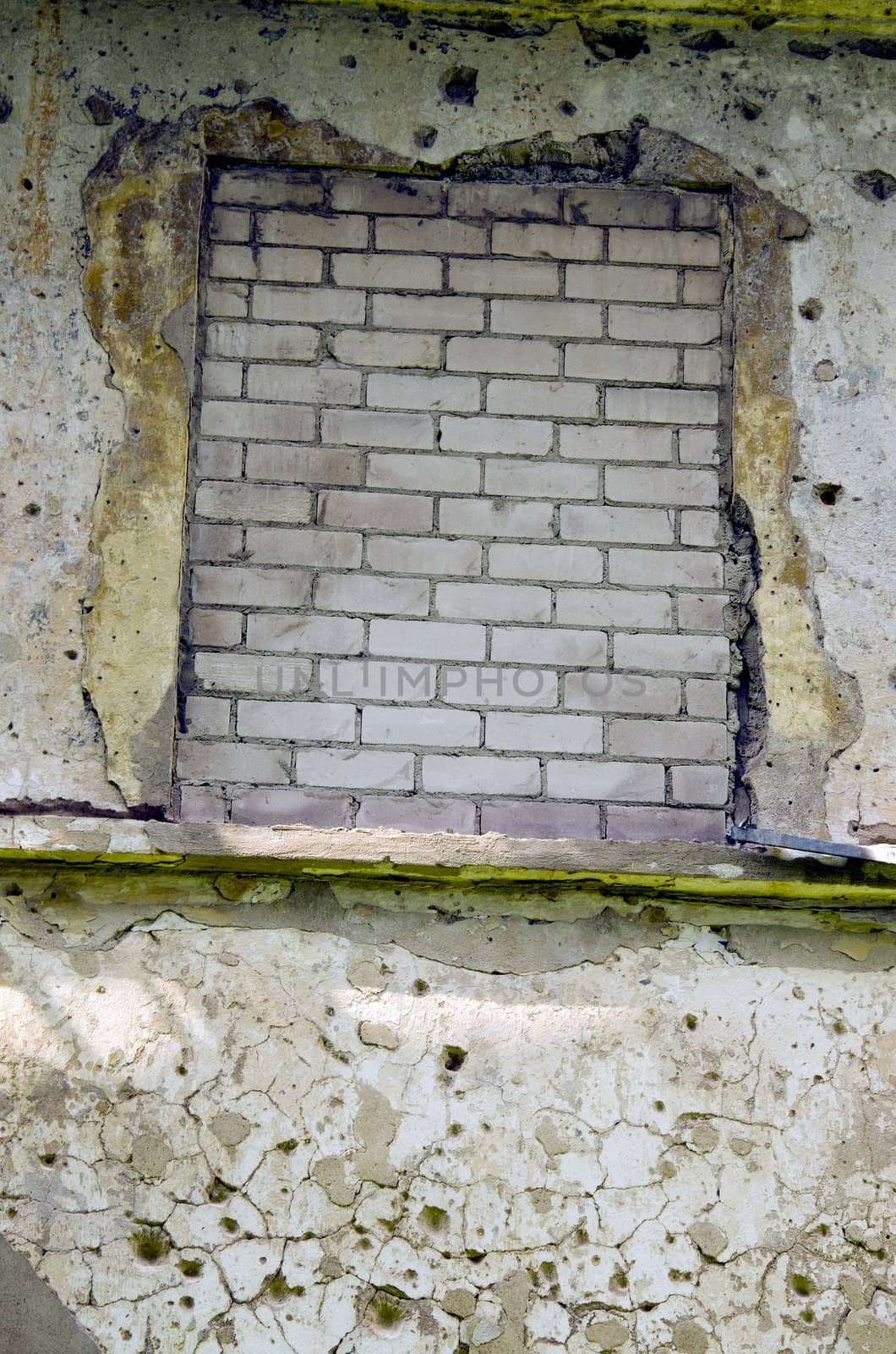 Window mure up with white bricks. Neglected architectural image.