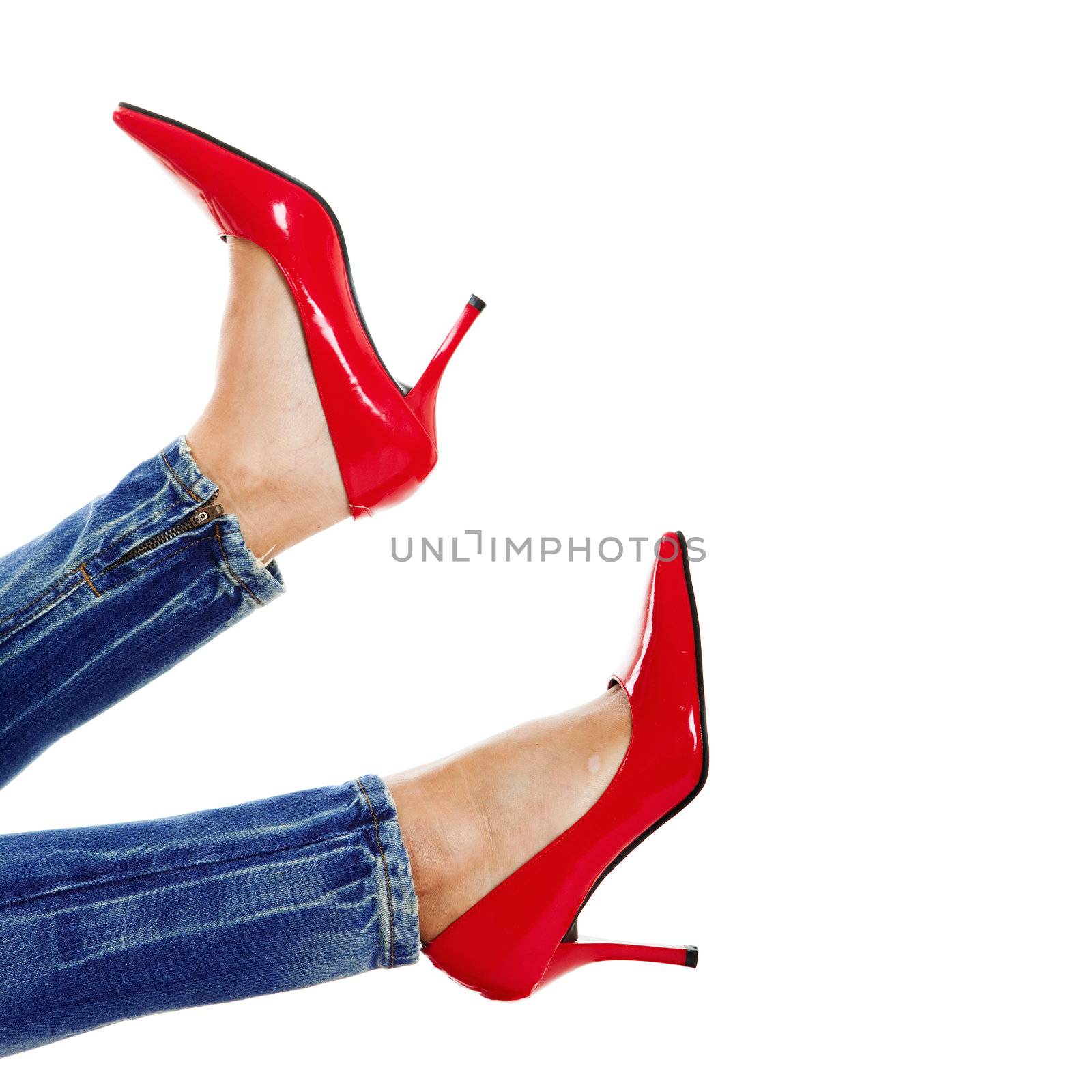 Female legs with sexy red shoes isolated in white